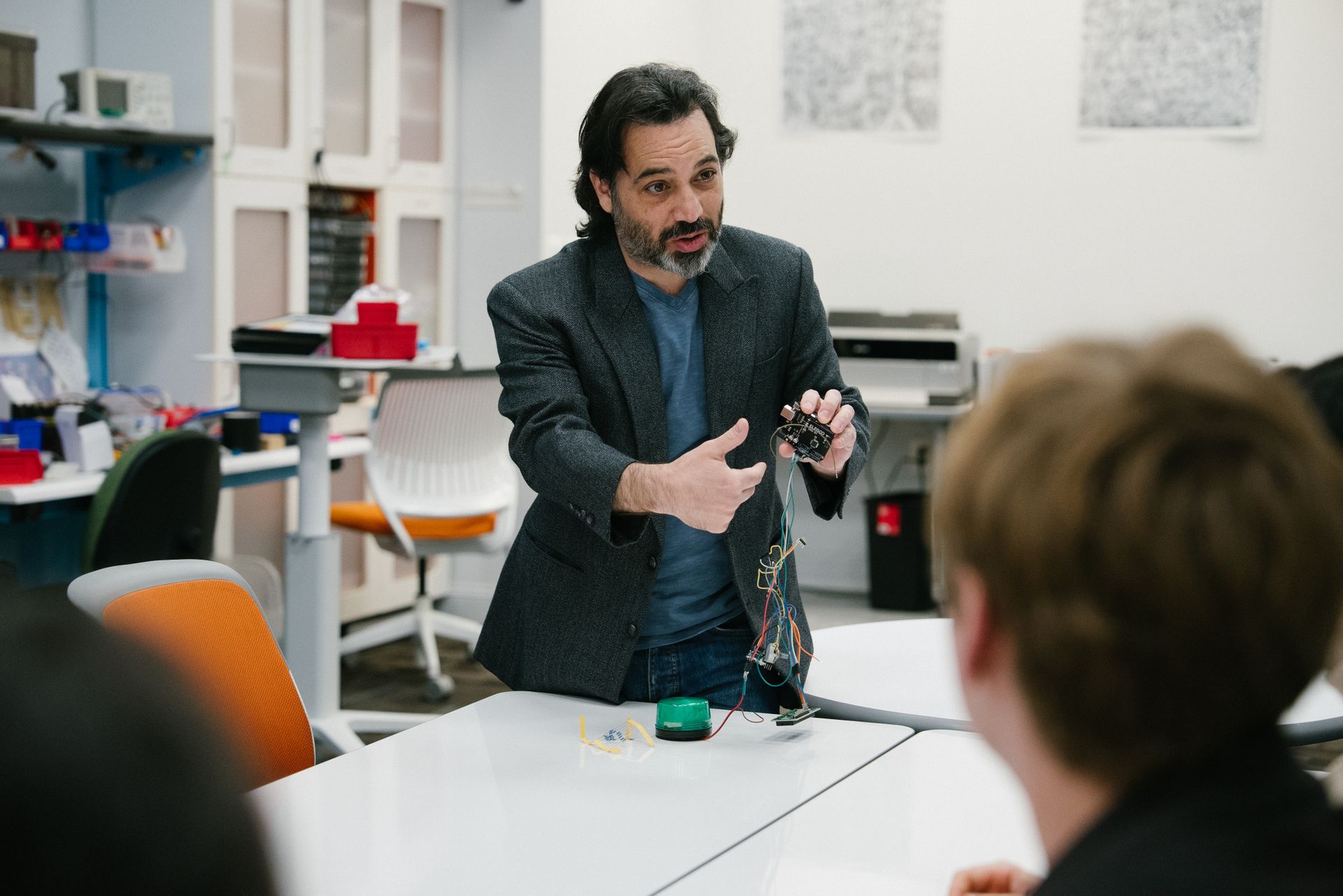 A faculty member presents a device.