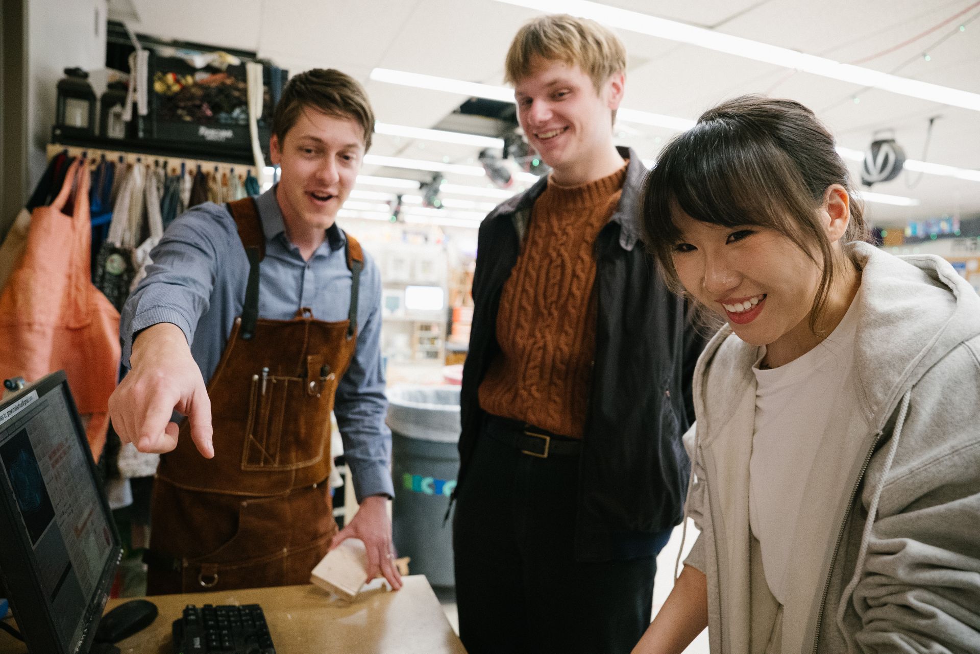 Students looks at a laptop in the maker lab.